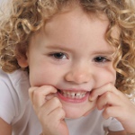 Why does the child grind his teeth?