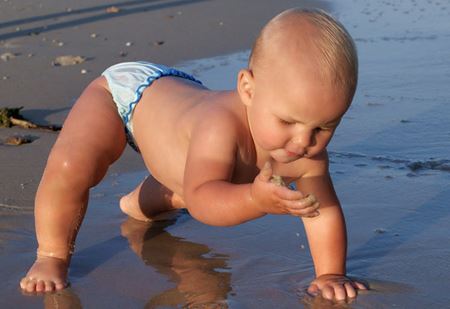 A child is walking on the beach