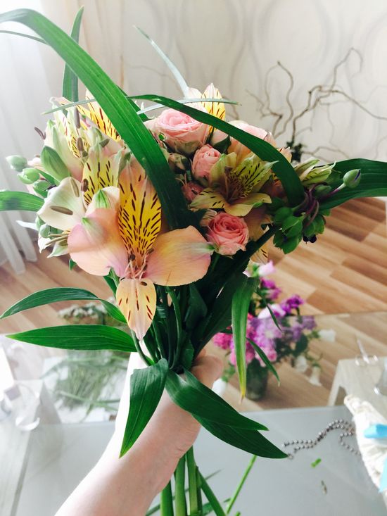 Add greens to a bouquet