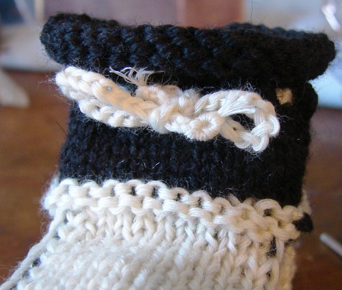 Black and white booties with knitting needles for summer