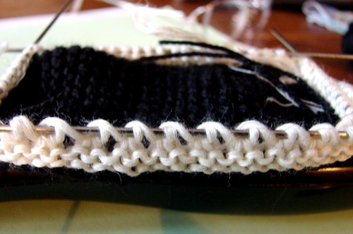 Black and white booties with knitting needles for summer