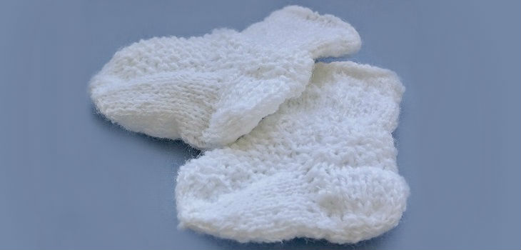 Knitted socks for a girl or a boy with a pattern. Knitting with needles for beginners