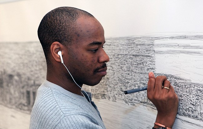 A man draws a big city