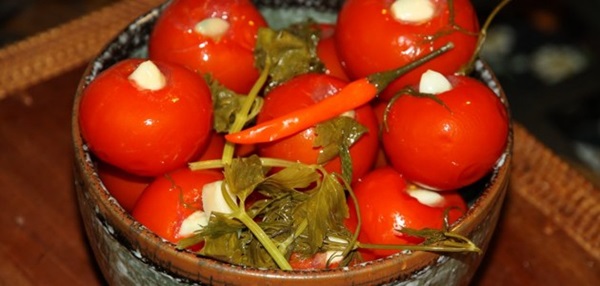 Freshly salted tomatoes in a bag and a saucepan