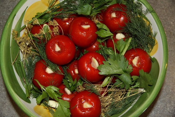Freshly salted tomatoes in a bag and a saucepan