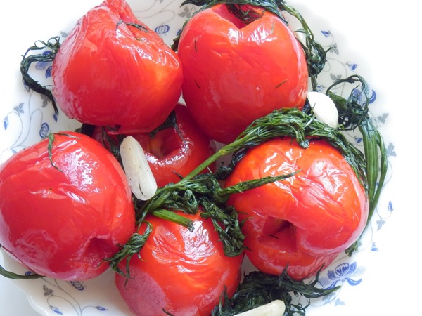 Freshly salted tomatoes in a bag and a saucepan