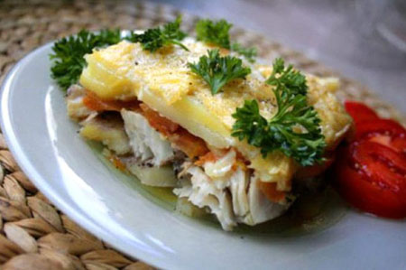 Baked fish in the oven under the tender sauce