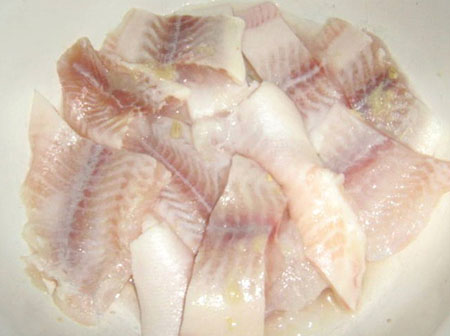 Baked fish in the oven under the tender sauce